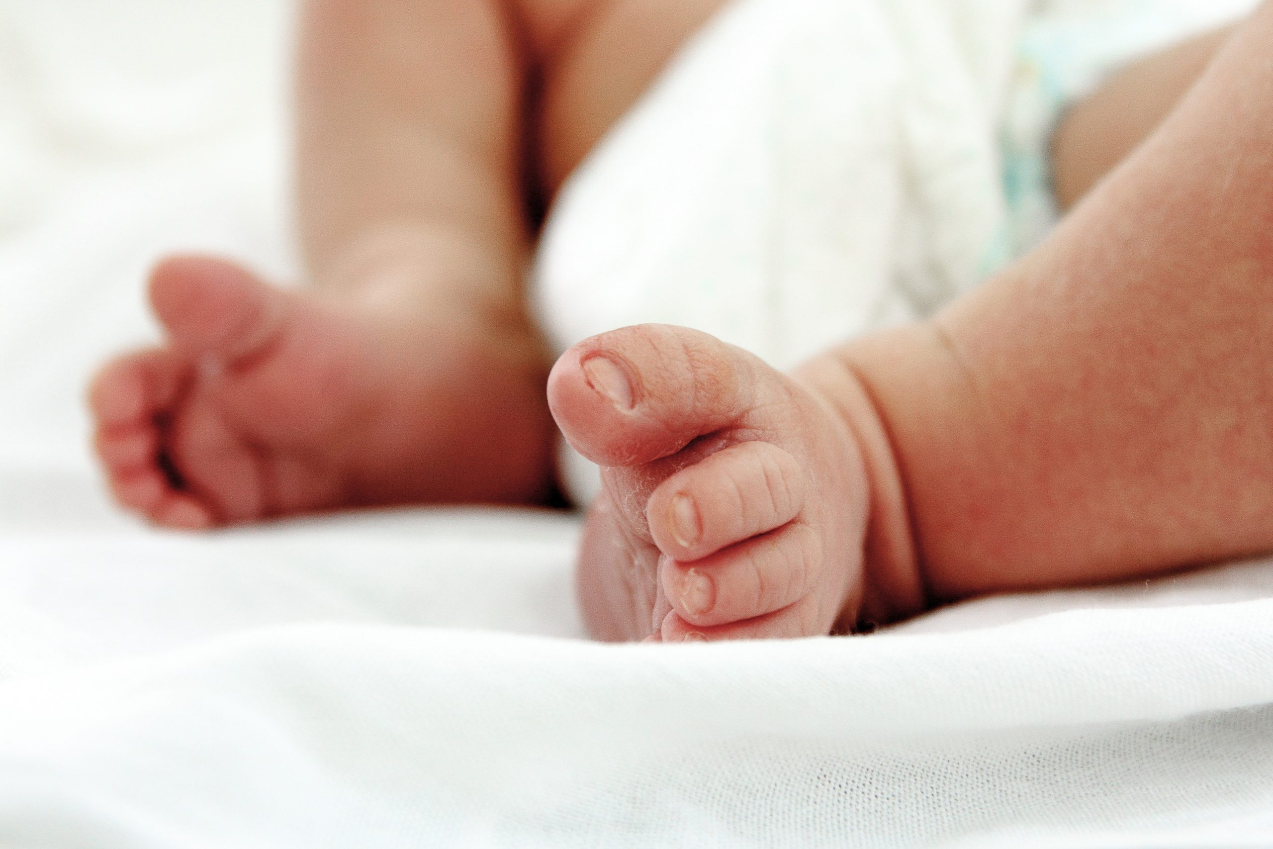 Newborn baby feet . Maternity hospital perinatal center motherhood